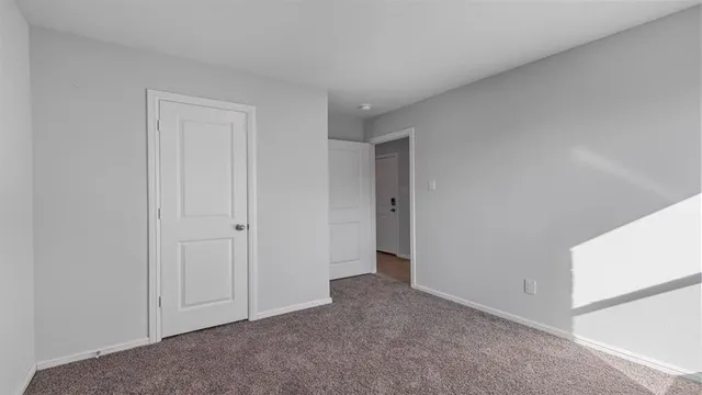 an empty room with closet area