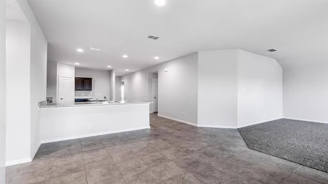a view of a kitchen with a sink and a refrigerator