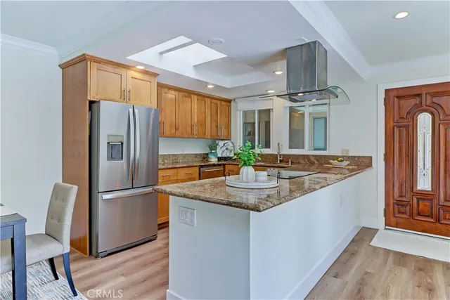 a kitchen with stainless steel appliances granite countertop a refrigerator and a sink