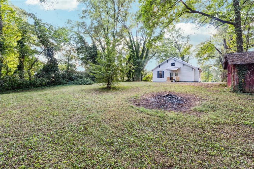 1820 Cassville Road Northwest Cartersville, GA 30121 - Photo 22 of 24 a front view of a house with a yard and garage