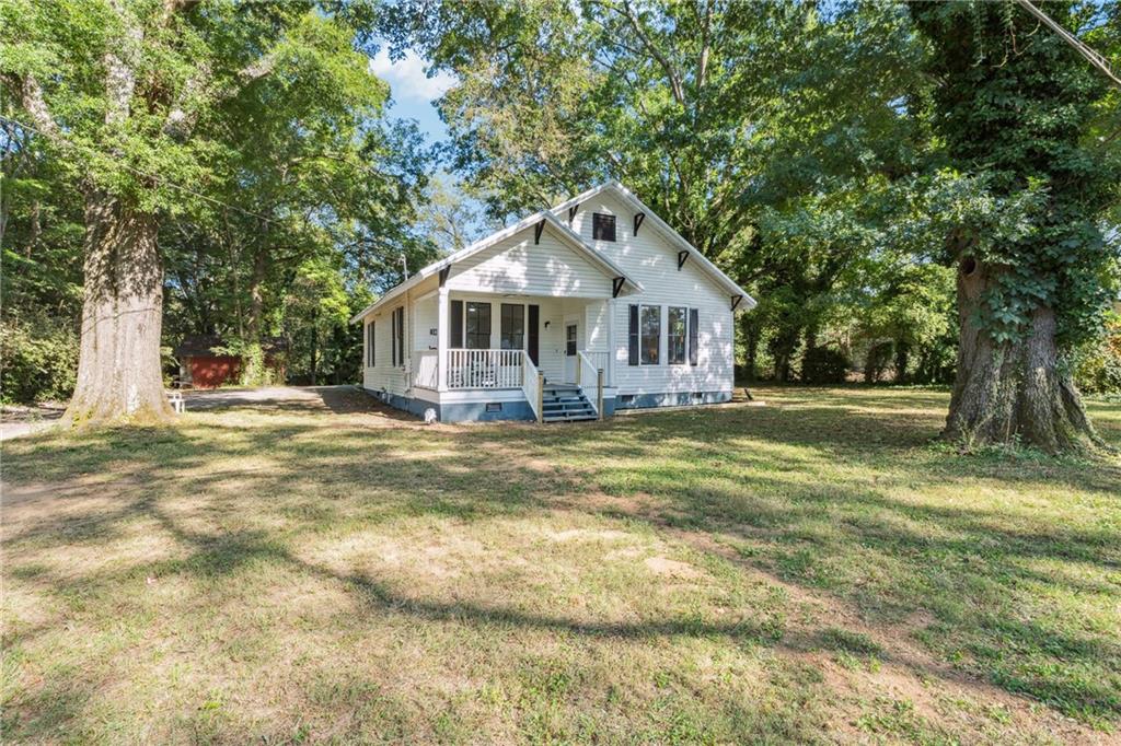 1820 Cassville Road Northwest Cartersville, GA 30121 - Photo 24 of 24 a front view of a house with a garden and trees