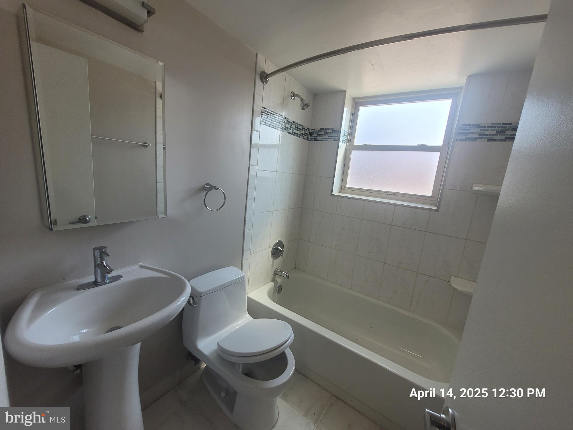2647 Martin Luther King Jr Avenue Southeast, Unit 203 Washington, DC 20020 - Photo 13 of 28 a bathroom with a sink a toilet and shower