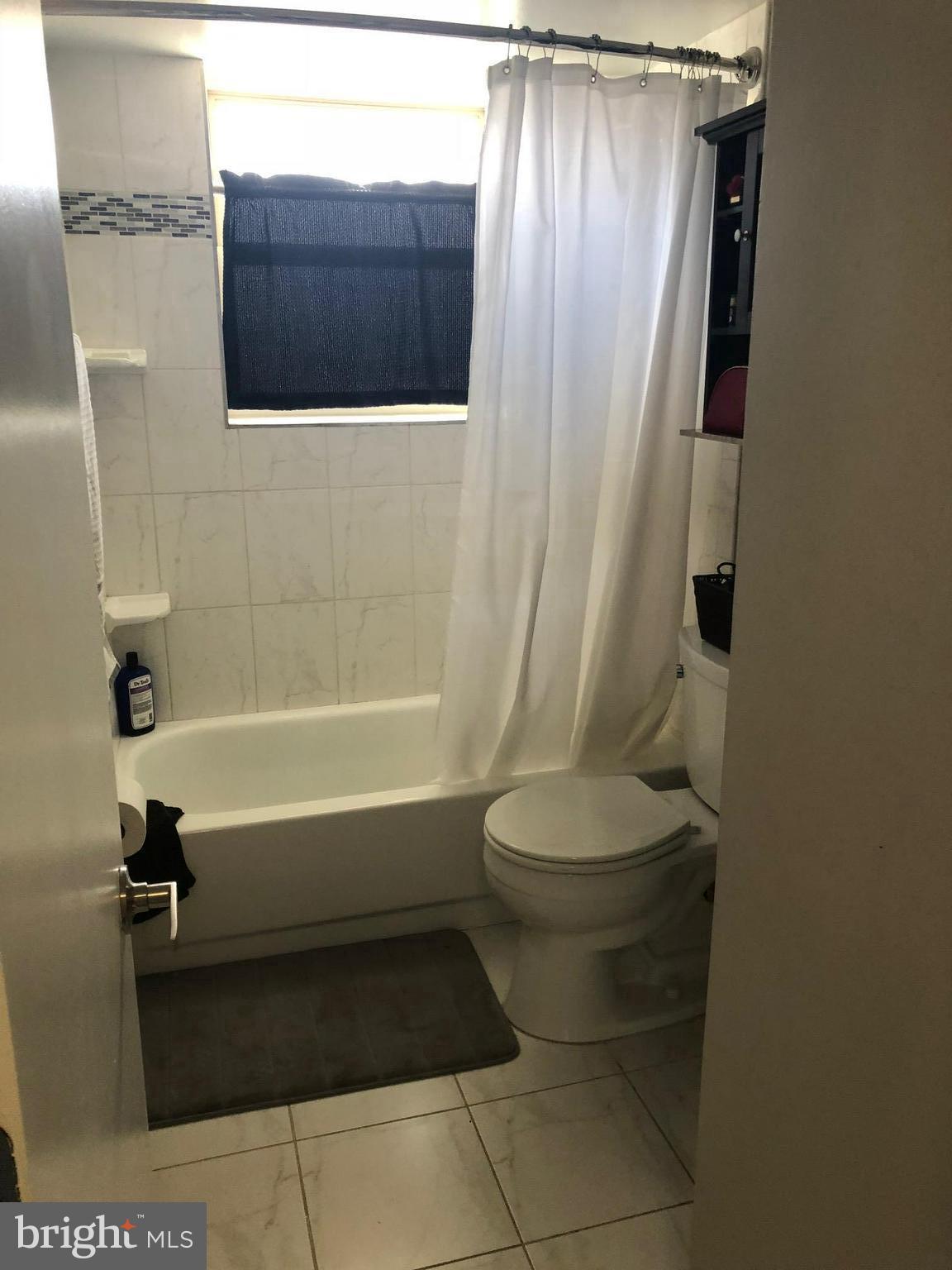 2647 Martin Luther King Jr Avenue Southeast, Unit 203 Washington, DC 20020 - Photo 14 of 28 a bathroom with a toilet and a shower