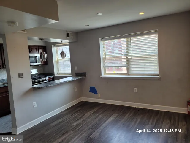 a room with wooden floor and gym equipment