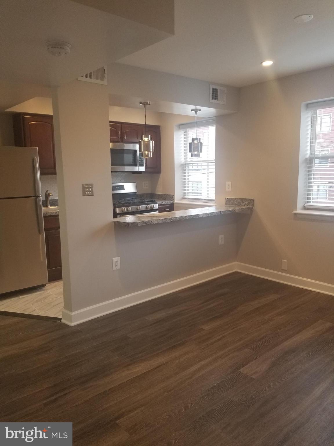 2647 Martin Luther King Jr Avenue Southeast, Unit 203 Washington, DC 20020 - Photo 5 of 28 an empty room with wooden floor and windows