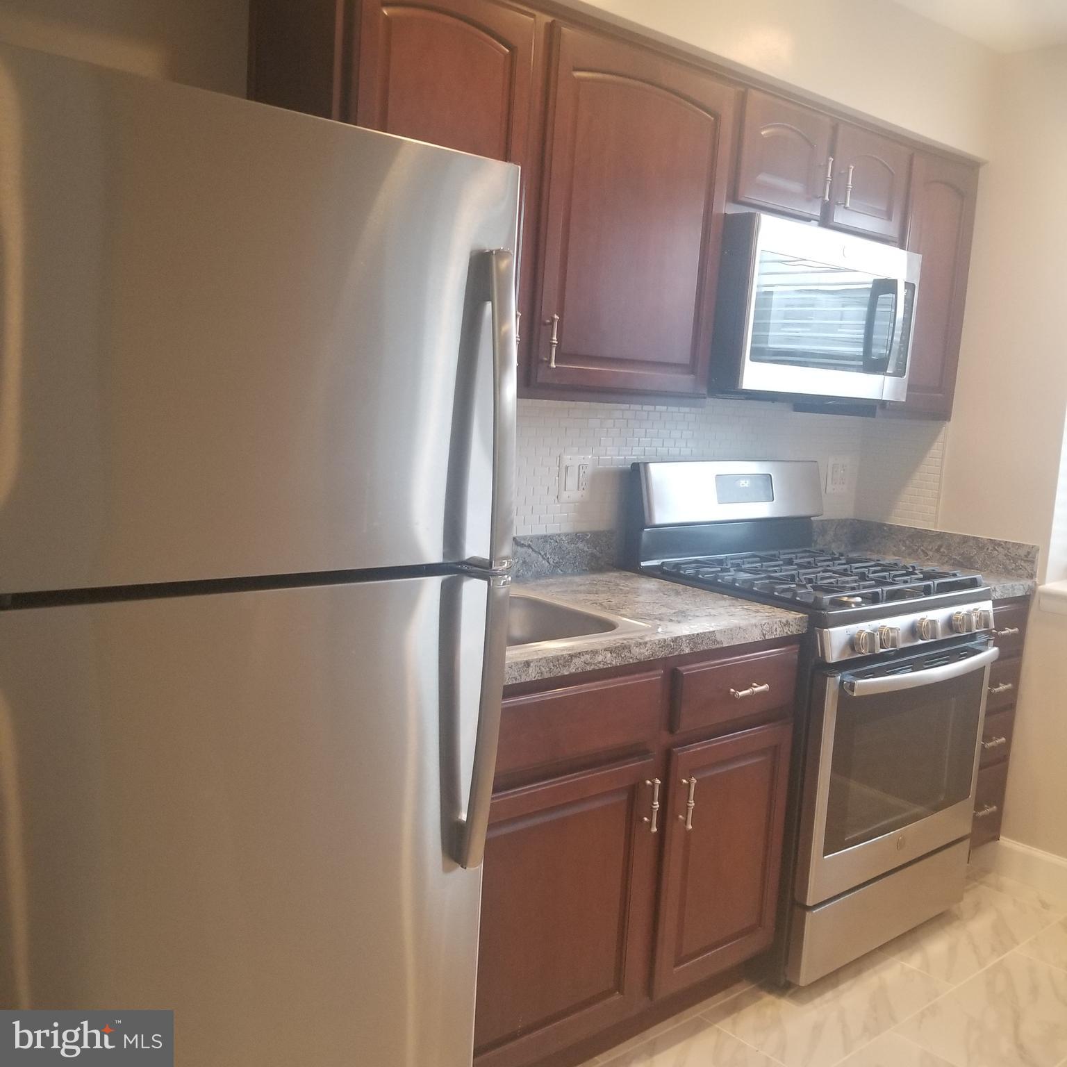 2647 Martin Luther King Jr Avenue Southeast, Unit 203 Washington, DC 20020 - Photo 7 of 28 a view of a kitchen with a sink and a refrigerator