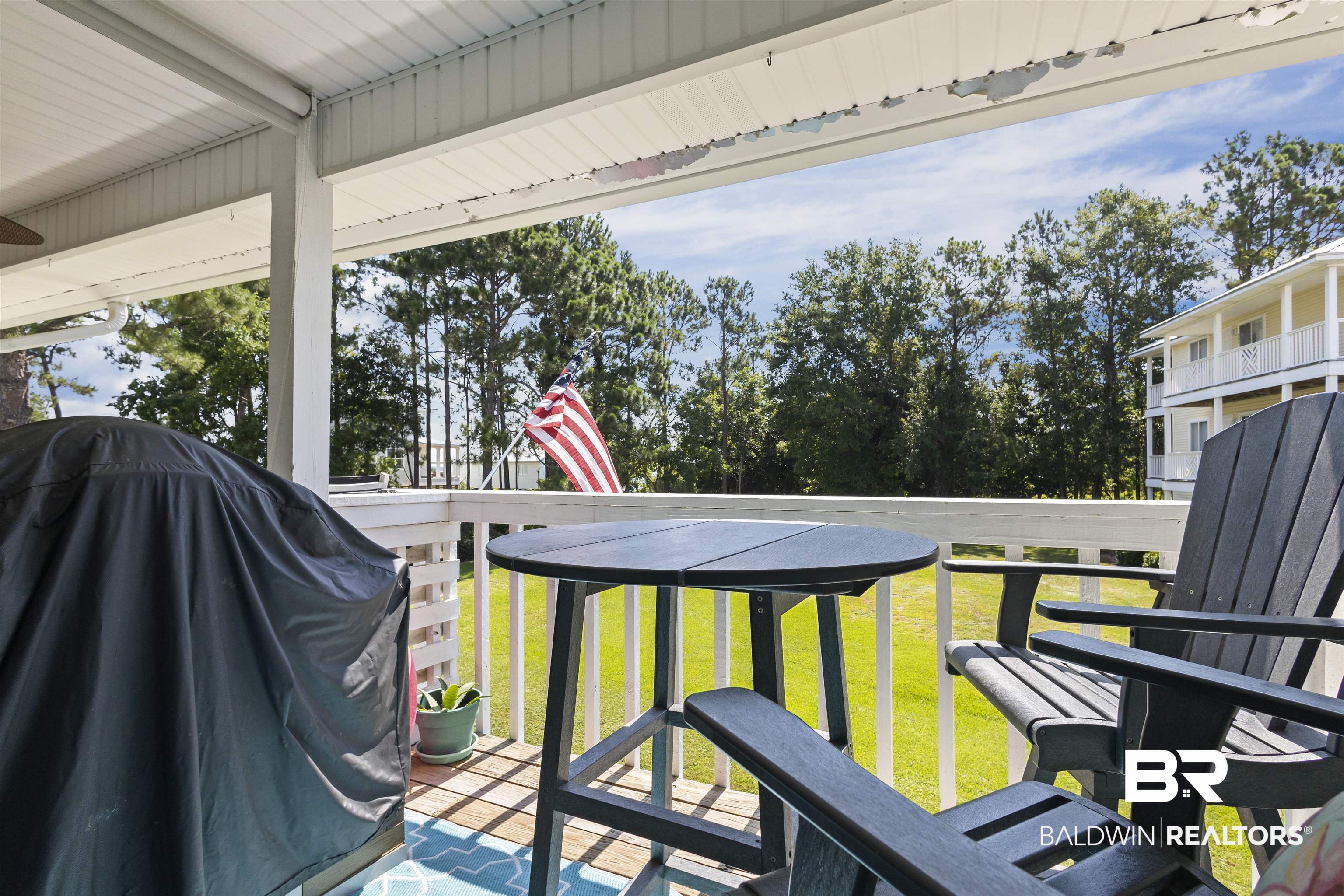 25925 Canal Road, Unit 207 Orange Beach, AL 36561 - Photo 30 of 42 Wooden terrace featuring a lawn