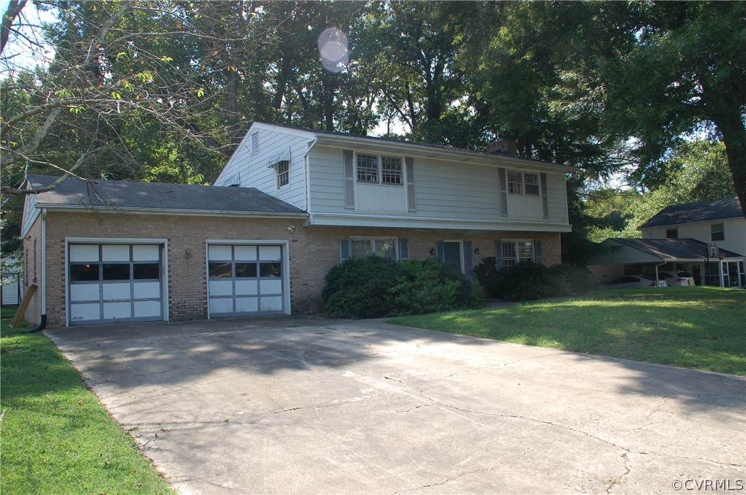 1213 Covington Road Colonial Heights, VA 23834 - Photo 1 of 33 a front view of a house with a garden and yard