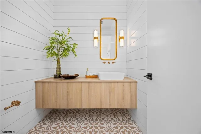 a bedroom with a bed a dresser and chair