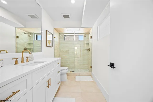 a bathroom with a sink a mirror and a shower