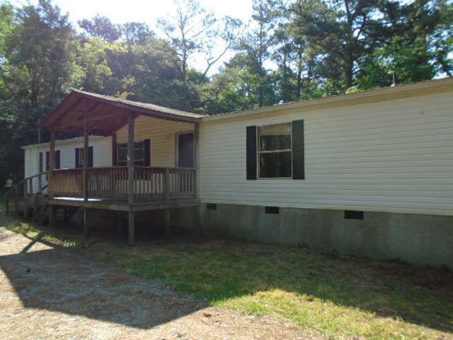 3152 Upper River Road Macon, GA 31211 - Photo 2 of 12 a backyard of a house with wooden deck and outdoor seating