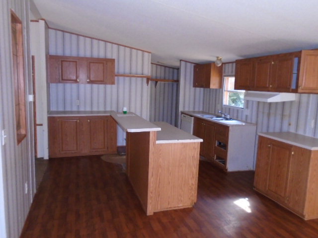 3152 Upper River Road Macon, GA 31211 - Photo 4 of 12 a kitchen with wooden cabinets and a wooden floor