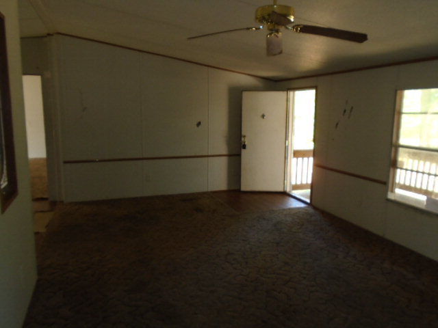 3152 Upper River Road Macon, GA 31211 - Photo 5 of 12 wooden floor in an empty room with a window