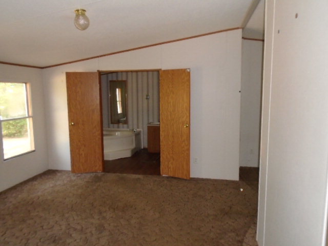 3152 Upper River Road Macon, GA 31211 - Photo 6 of 12 a view of a room with a hallway and wooden shelves