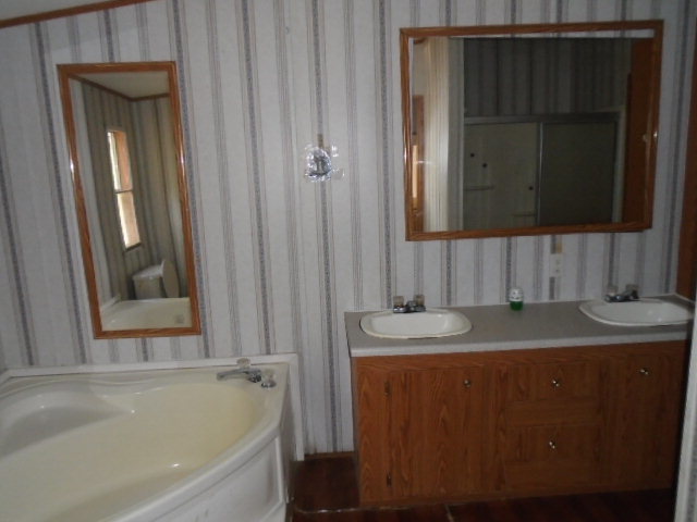 3152 Upper River Road Macon, GA 31211 - Photo 7 of 12 a bathroom with a granite countertop sink and mirror with bathtub