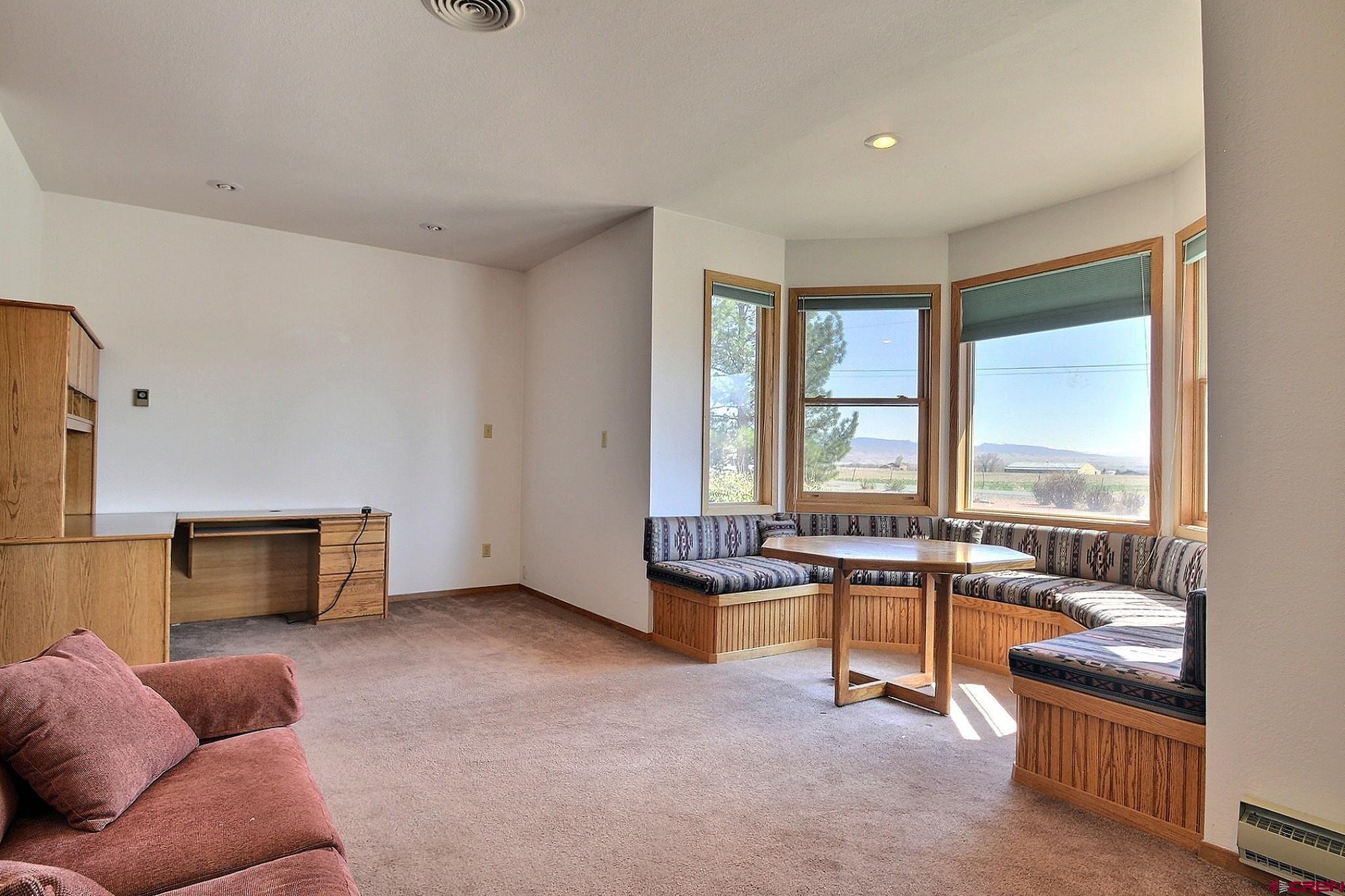 21061 Ivanhoe Road Austin, CO 81410 - Photo 12 of 24 a living room with furniture and a flat screen tv