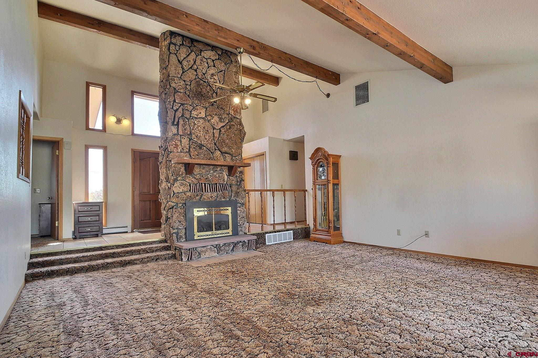 21061 Ivanhoe Road Austin, CO 81410 - Photo 4 of 24 a view of a house with a small yard and wooden floor