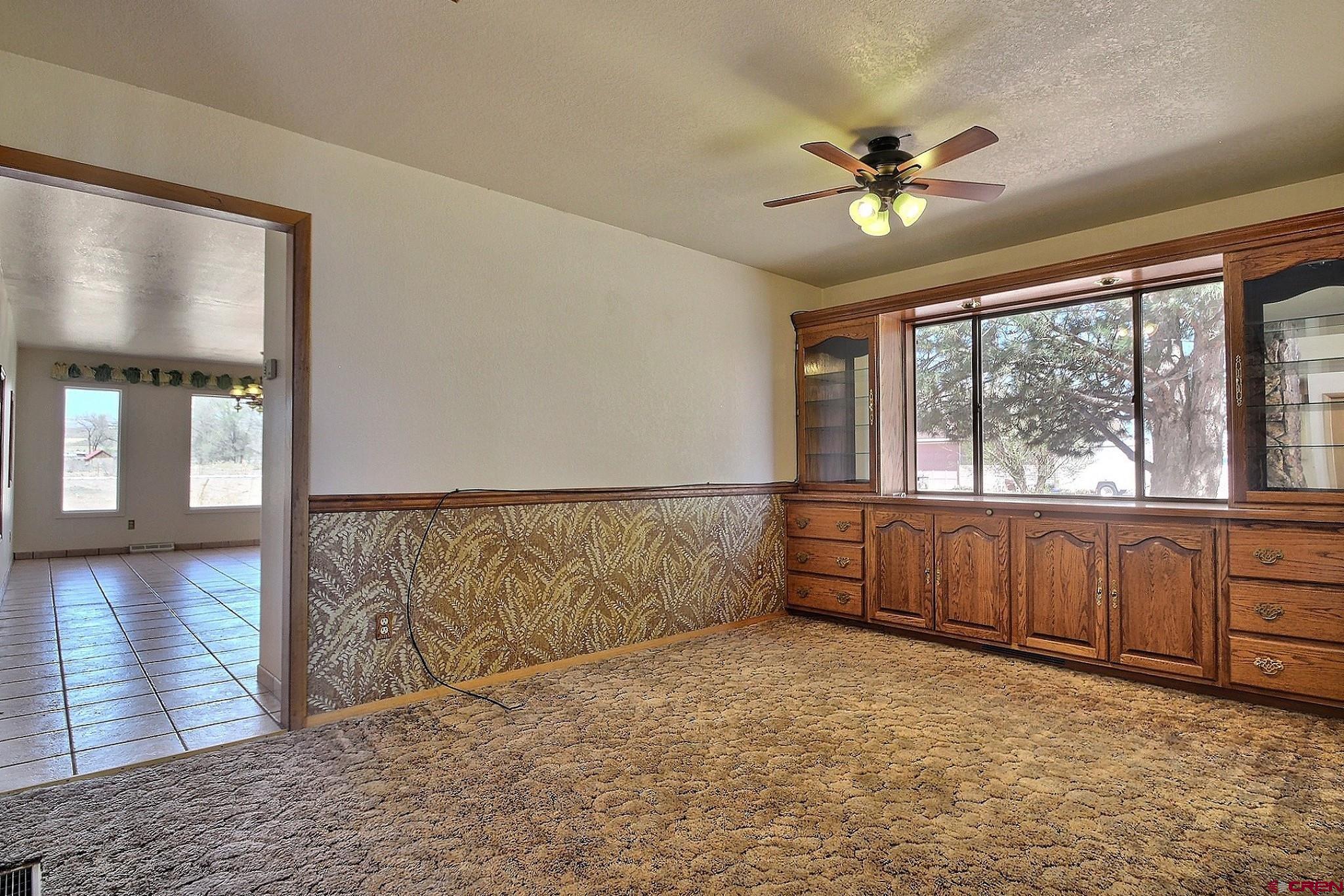 21061 Ivanhoe Road Austin, CO 81410 - Photo 5 of 24 wooden floor in an empty room with a window