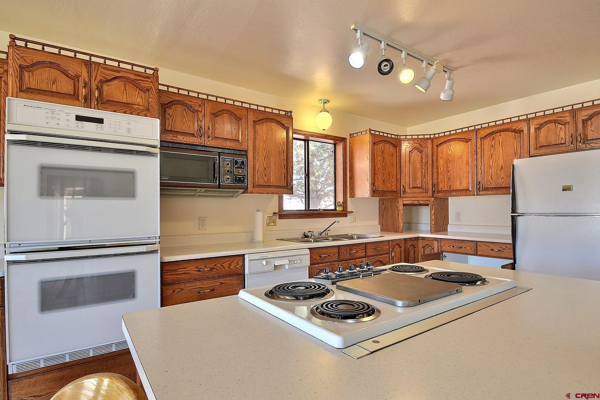 21061 Ivanhoe Road Austin, CO 81410 - Photo 8 of 24 a kitchen with a stove a sink and a refrigerator