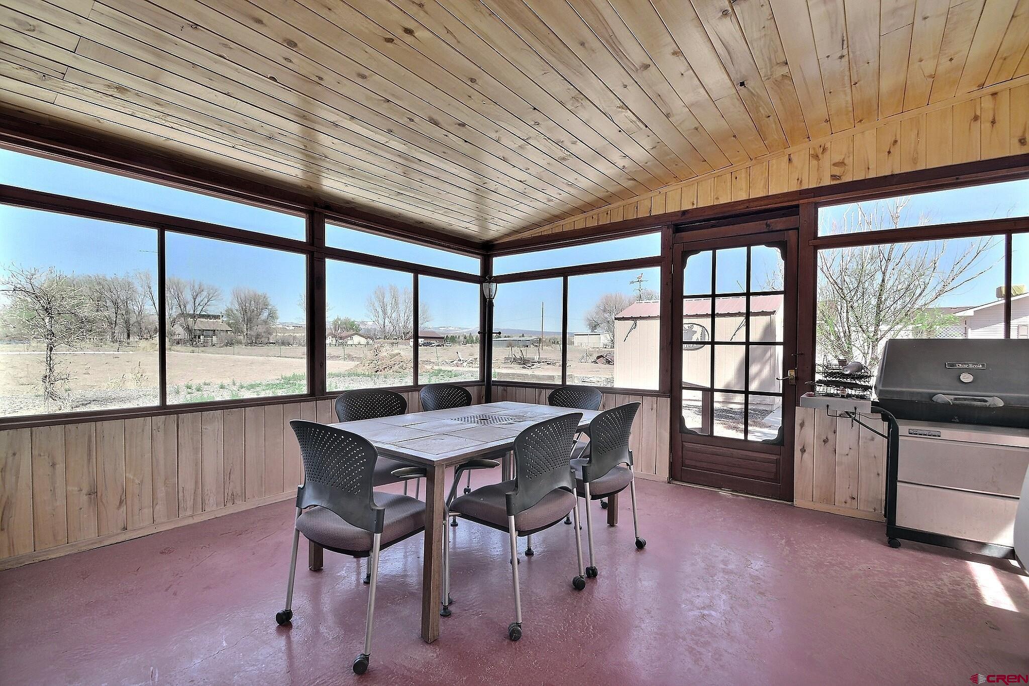 21061 Ivanhoe Road Austin, CO 81410 - Photo 10 of 24 a view of a dining room with furniture and a window