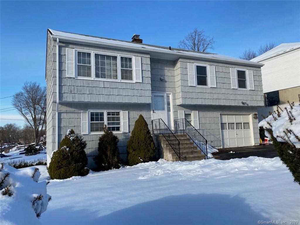 24 Nostrum Road Norwalk, CT 06850 - Photo 1 of 1 a front view of a house with a yard