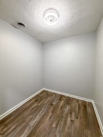 a view of a room with wooden floor