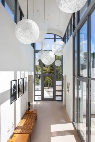 a bed room with a bed and a large window