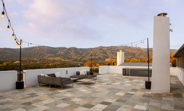 a view of a balcony with wooden floor and outdoor space