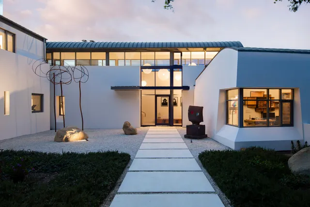 a man sitting on a bench in front of a building