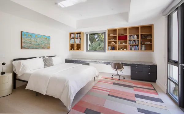 a bedroom with a bed and a couch