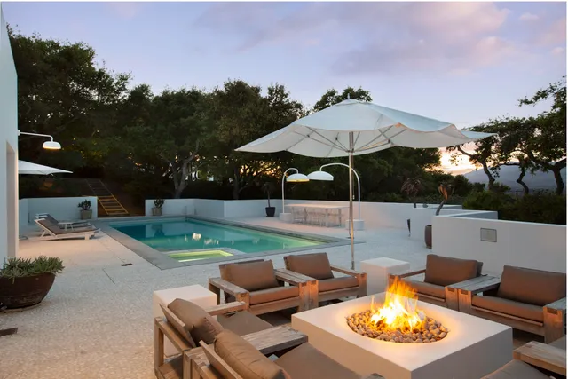 a view of a house with swimming pool and sitting area