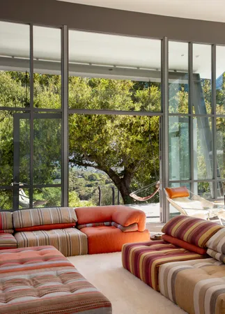 a bedroom with furniture and large windows
