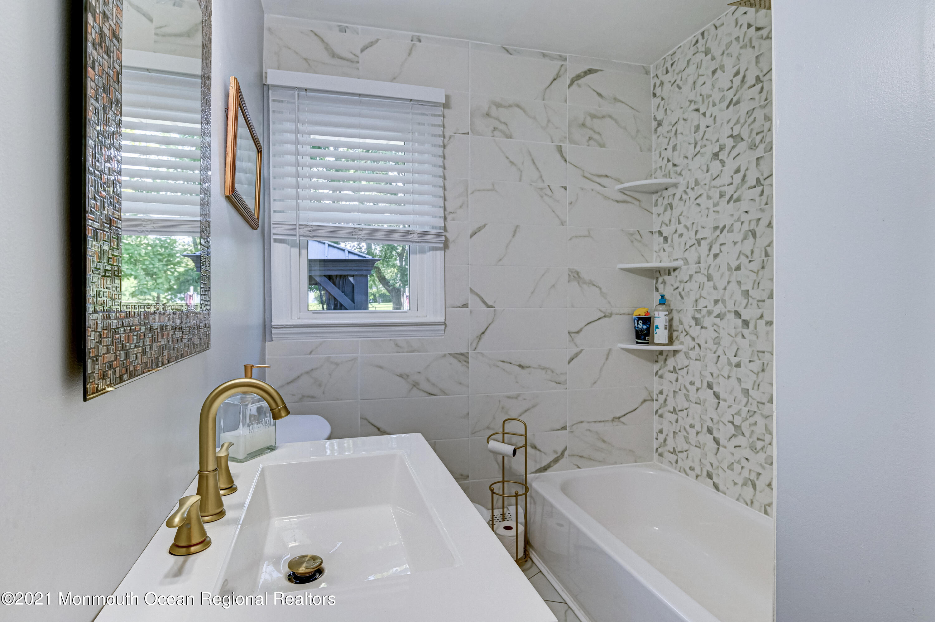 116 Bethany Road Hazlet, NJ 07730 - Photo 19 of 30 a bathroom with a sink a bathtub and a window