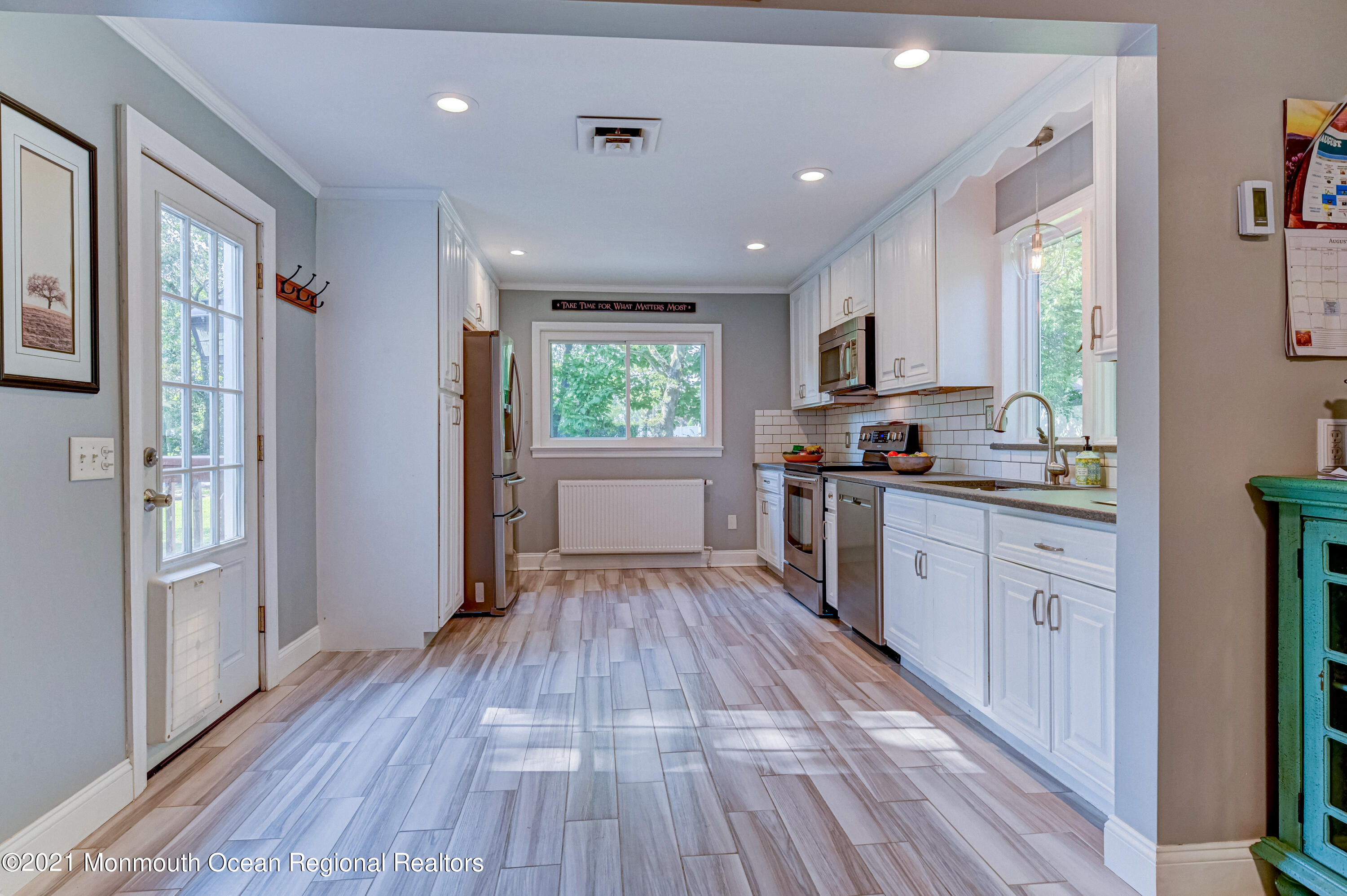 116 Bethany Road Hazlet, NJ 07730 - Photo 8 of 30 a kitchen with wooden floors and wooden cabinets