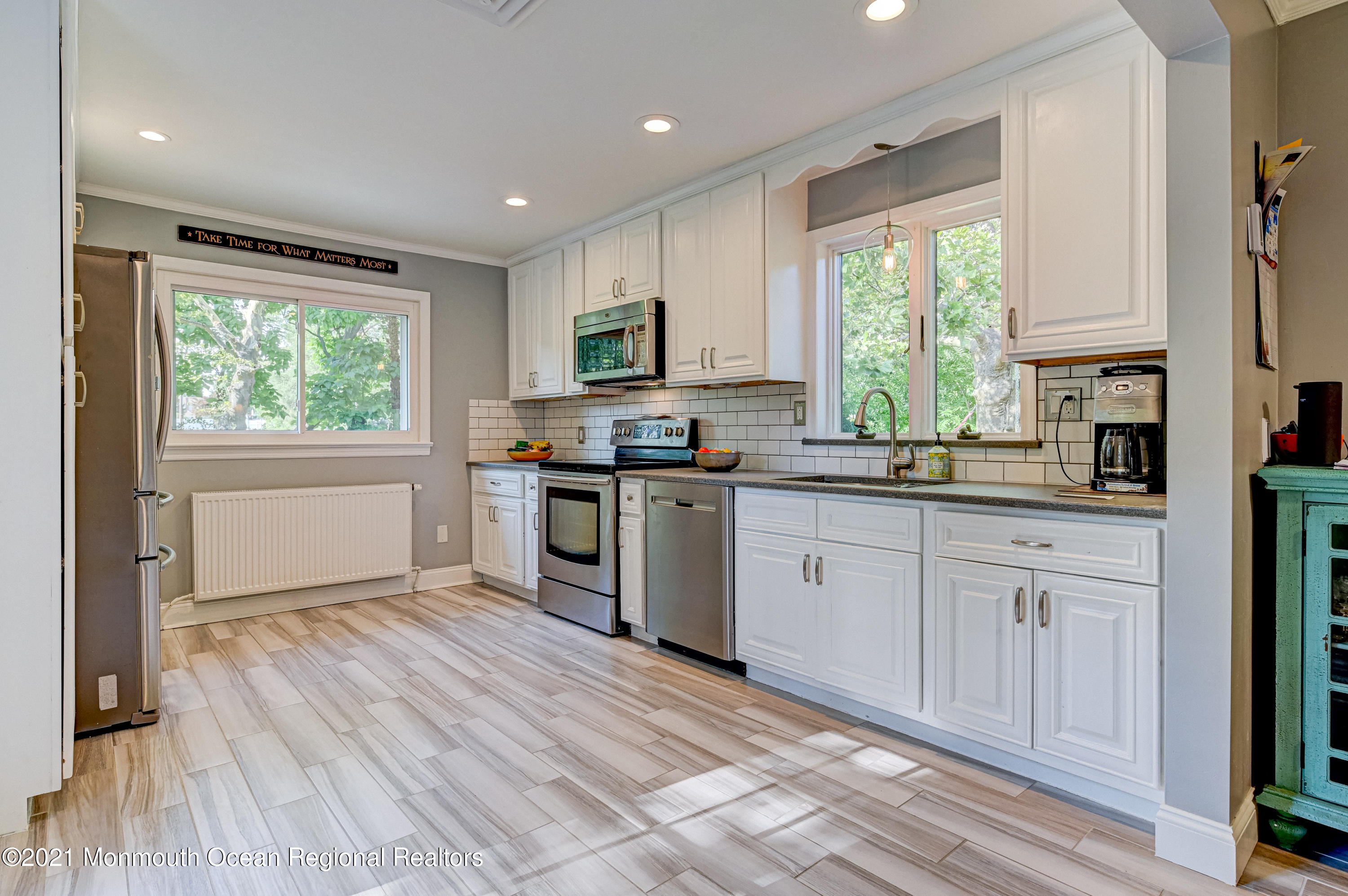 116 Bethany Road Hazlet, NJ 07730 - Photo 9 of 30 a kitchen with granite countertop a stove a sink dishwasher and a microwave oven with wooden floor