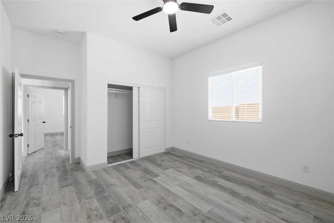 1061 Factory Road Pahrump, NV 89048 - Photo 22 of 41 A well-lit bedroom features durable laminate flooring and a spacious closet.