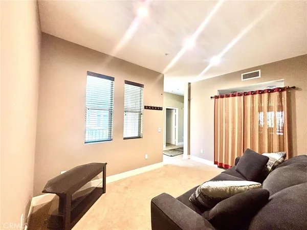 a bedroom with furniture and a large window