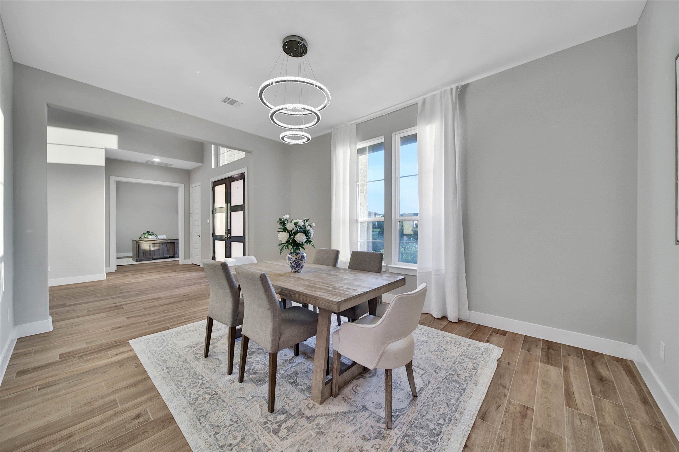 29402 Cir S Rnch Trail Fulshear, TX 77406 - Photo 4 of 50 The formal dining room is beautifully accented by an elegant crystal chandelier, adding timeless style and sophistication. It’s the perfect space for hosting holiday dinners or special gatherings.