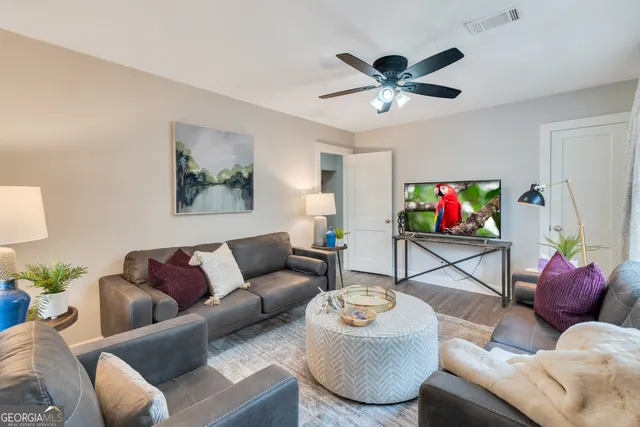 a living room with furniture and a flat screen tv