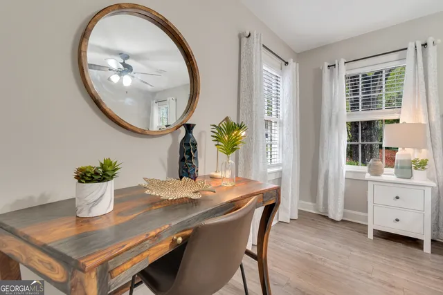 a view of a dining room with furniture and a potted plant