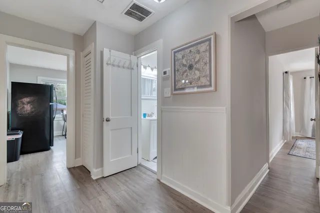 a view of a hallway with wooden floor
