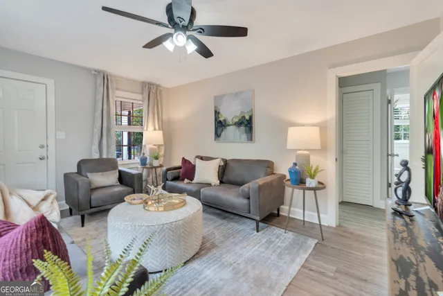 a living room with furniture and a wooden floor