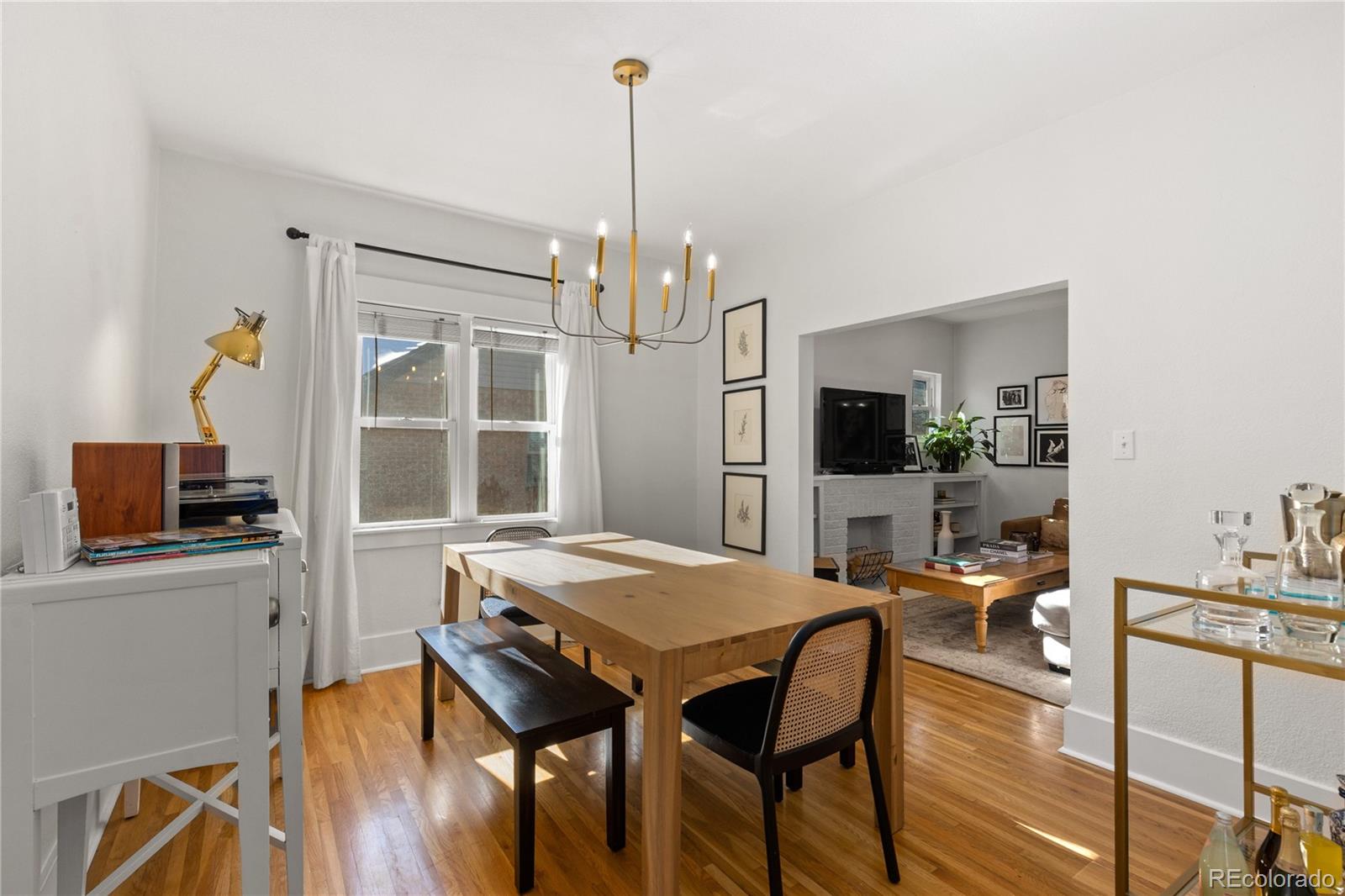 2740 Fillmore Street Denver, CO 80205 - Photo 12 of 45 a view of a dining room with furniture window and wooden floor