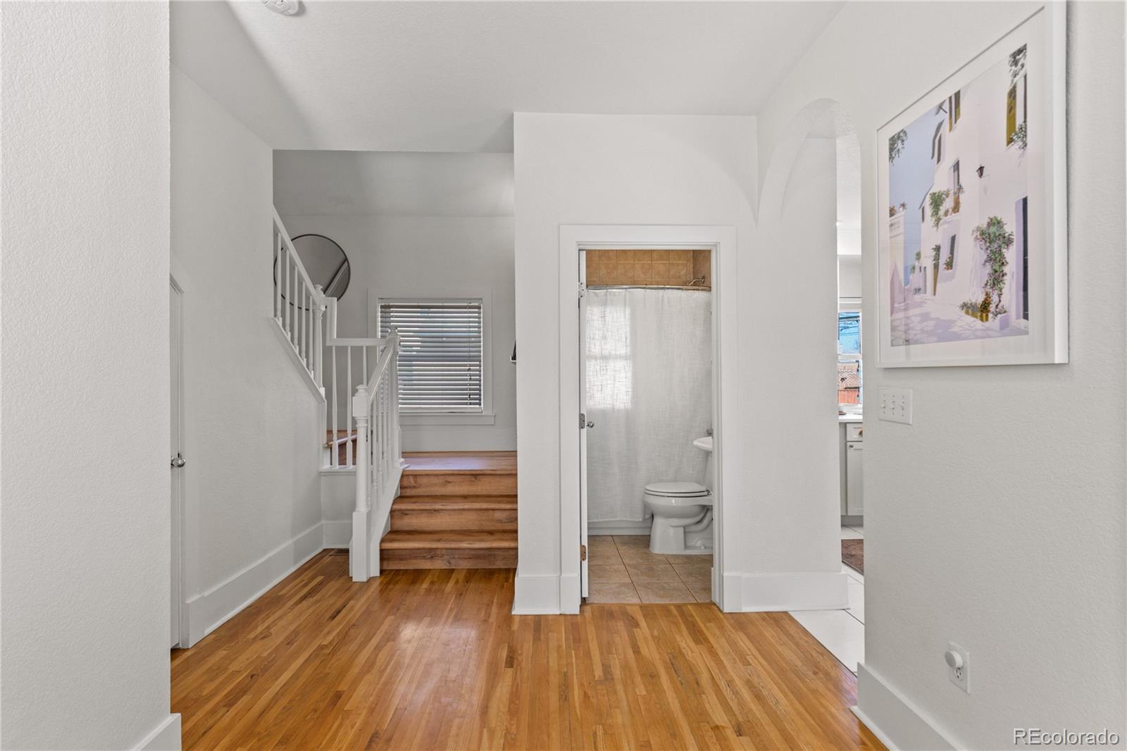 2740 Fillmore Street Denver, CO 80205 - Photo 15 of 45 a view of a hallway with wooden floor and entryway