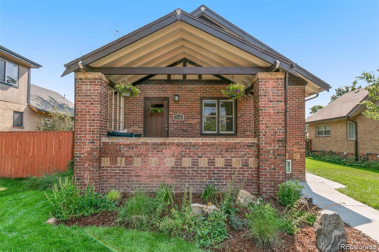 2740 Fillmore Street Denver, CO 80205 - Photo 3 of 45 a front view of a house with garden