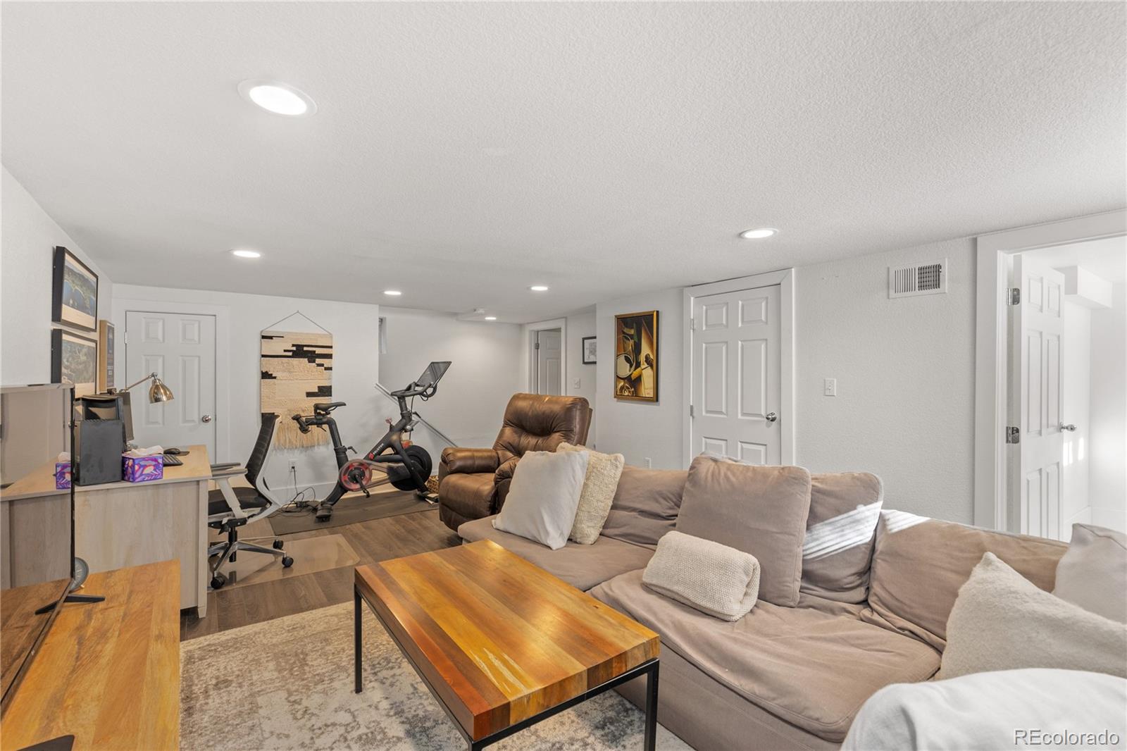 2740 Fillmore Street Denver, CO 80205 - Photo 33 of 45 a living room with furniture kitchen view and a wooden floor
