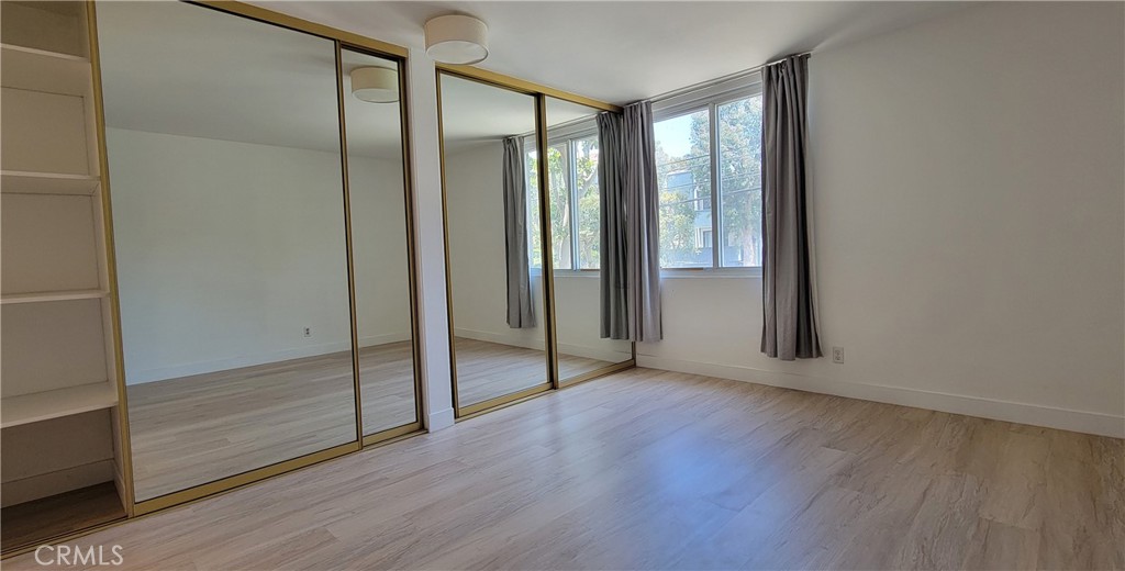8740 Tuscany Avenue Playa del Rey, CA 90293 - Photo 11 of 21 an empty room with wooden floor and door