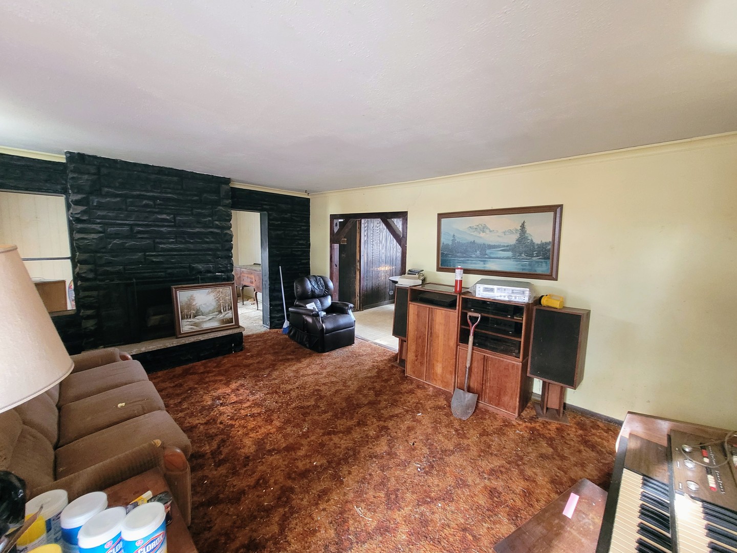 14340 Kostner Avenue Midlothian, IL 60445 - Photo 3 of 15 a living room with furniture a fireplace and a flat screen tv