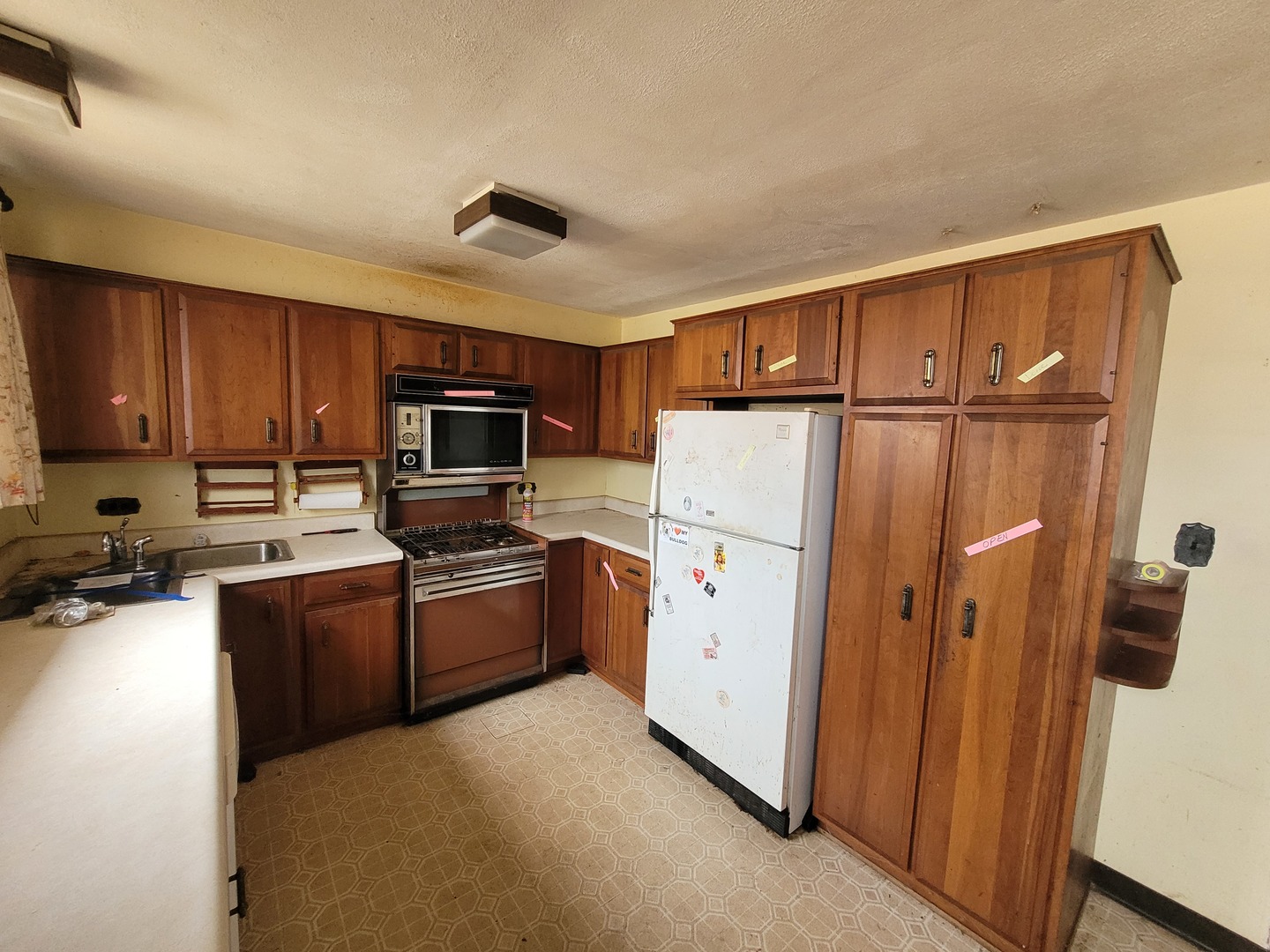 14340 Kostner Avenue Midlothian, IL 60445 - Photo 5 of 15 a kitchen with granite countertop a refrigerator a stove top oven a sink and dishwasher with wooden floor