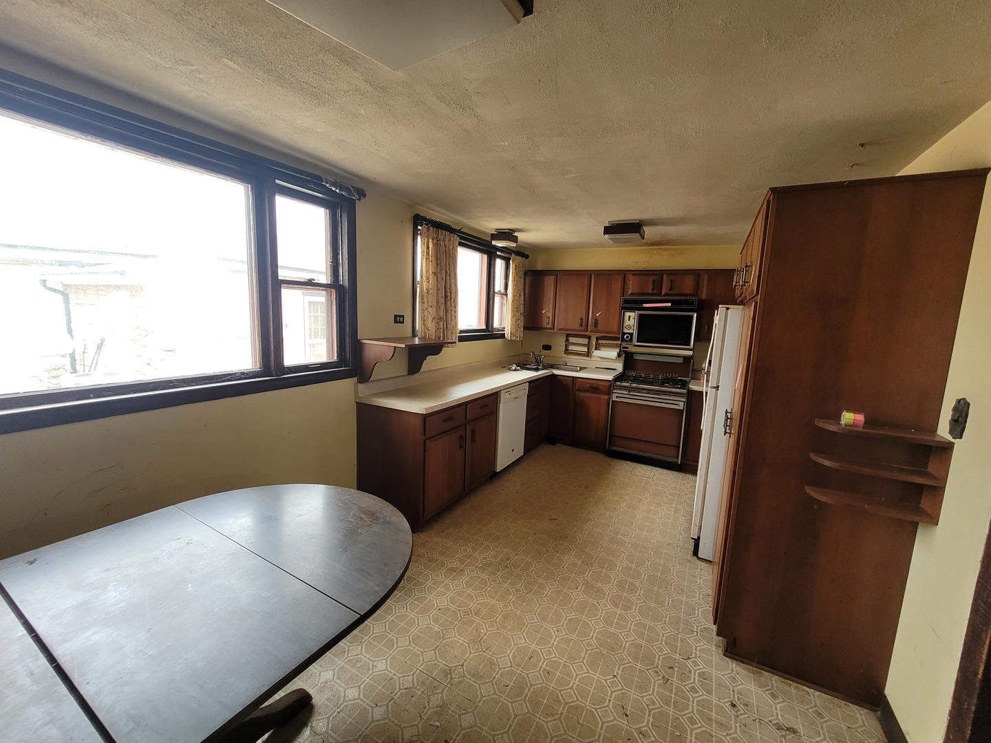 14340 Kostner Avenue Midlothian, IL 60445 - Photo 6 of 15 a kitchen with stainless steel appliances kitchen island granite countertop a refrigerator a sink a stove with wooden cabinets